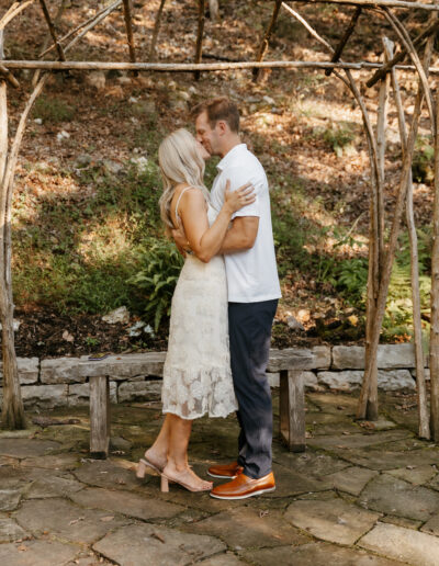 Man and woman sharing first kiss during eureka springs elopement