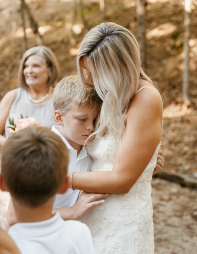 Bride hugs son after wedding ceremony